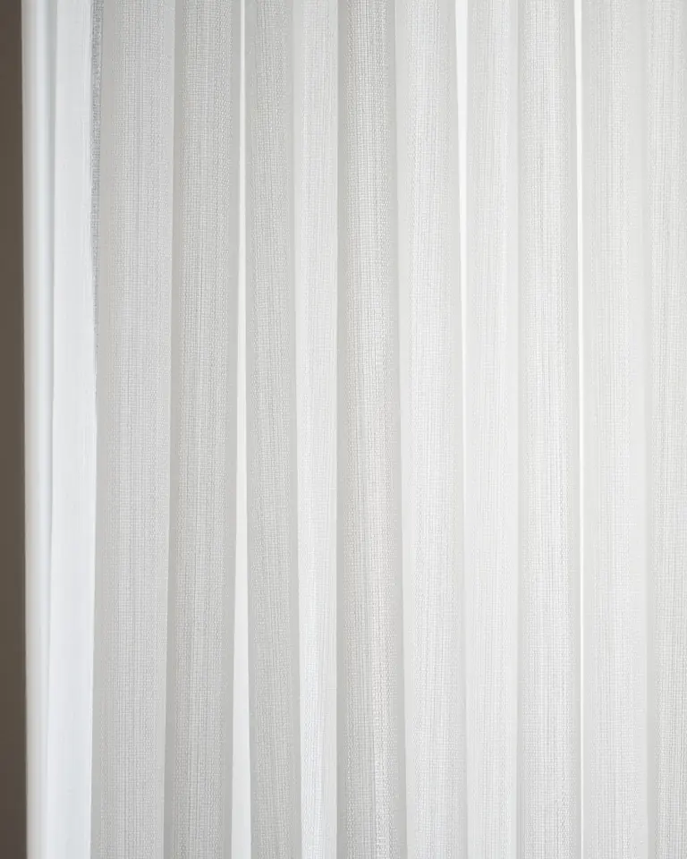 A white sheer in even vertical wave pleats, close up